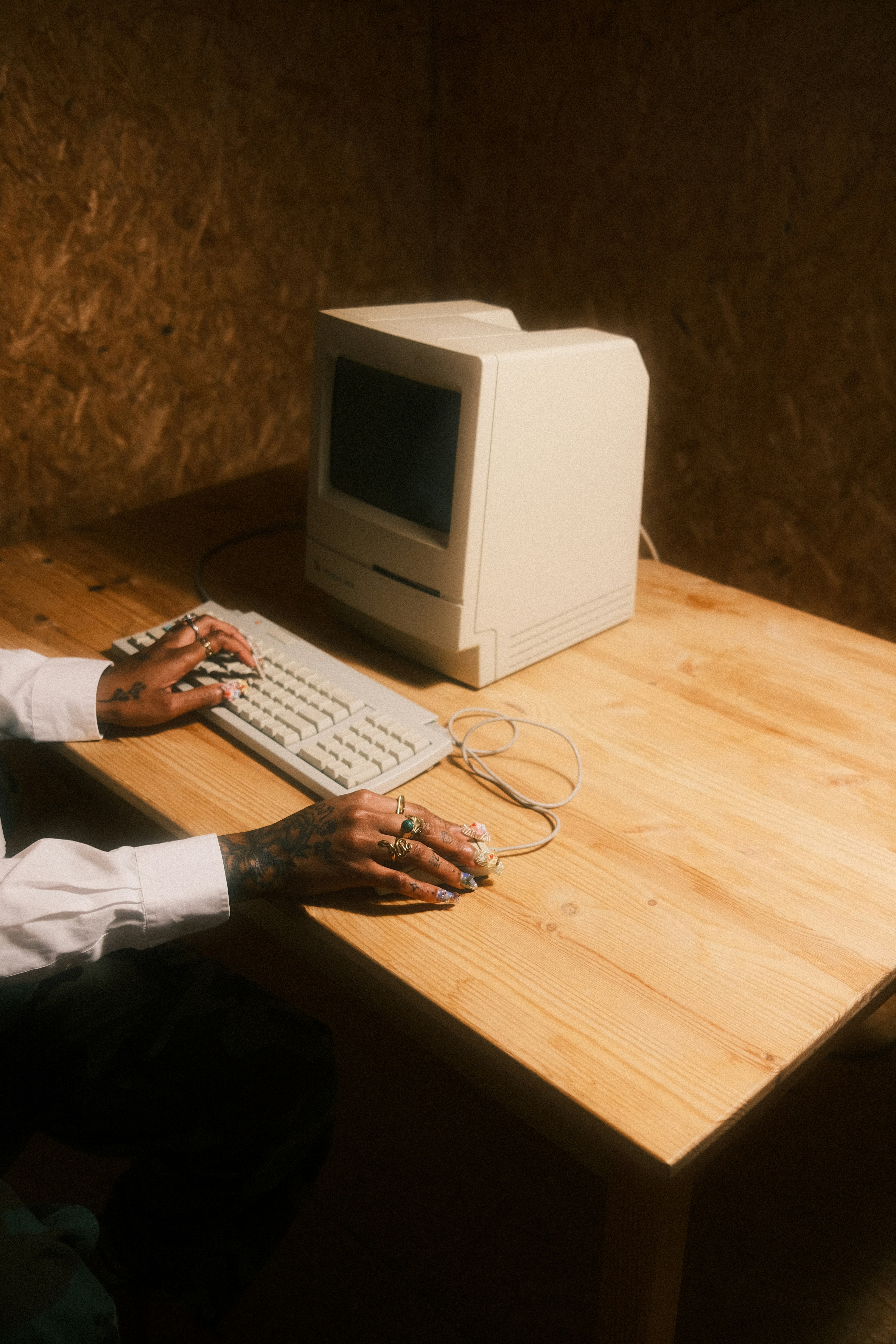Person in a white off-shoulder top using a MacBook laptop, with text overlay 'What's new in digital?' and the fabrica® logo in the top corner.